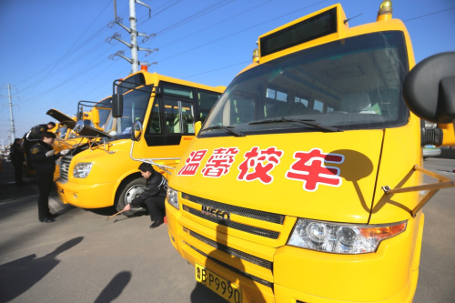 2月18日，山東青島交運集團即墨分公司的技術人員在檢查校車的安全狀況。新華社發（梁孝鵬 攝）