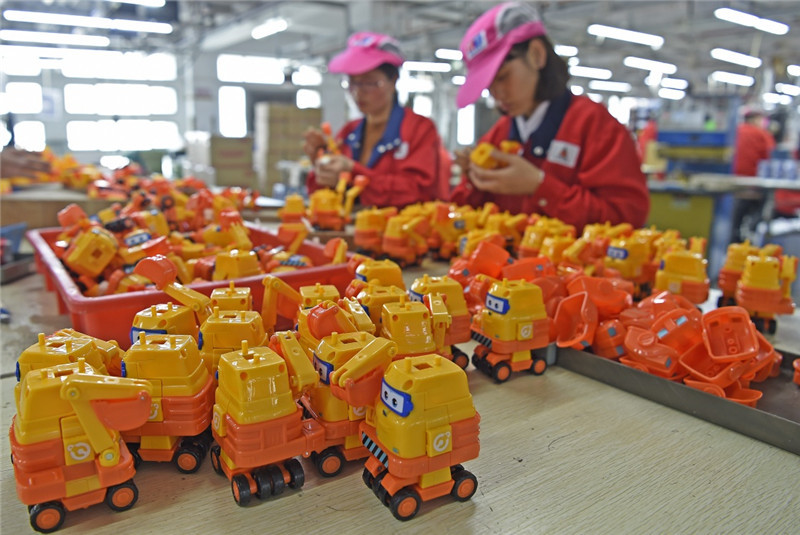 在汕头市澄海区,工人在一家玩具企业生产线上进行玩具组装加工